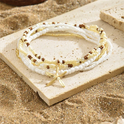 Tobillera Multicapa Estrella de Mar Verano Boho - Emeraldia Jewelry · Operado por R. E. dos Santos LTDA · CNPJ: 45.450.979/0001-38