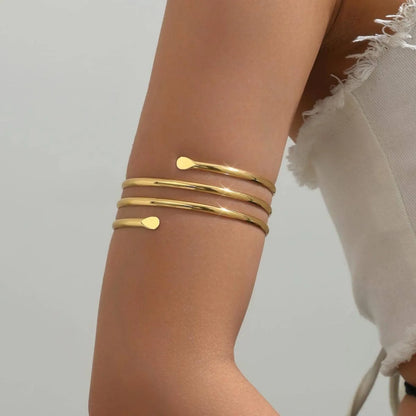 Brazalete de Brazo Abierto Dorado Cruzado Boho - Emeraldia Jewelry · Operado por R. E. dos Santos LTDA · CNPJ: 45.450.979/0001-38