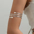 Brazalete de Brazo Abierto Dorado Cruzado Boho - Emeraldia Jewelry · Operado por R. E. dos Santos LTDA · CNPJ: 45.450.979/0001-38