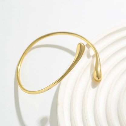 Brazalete de Brazo Dorado Minimalista - Emeraldia Jewelry · Operado por R. E. dos Santos LTDA · CNPJ: 45.450.979/0001-38