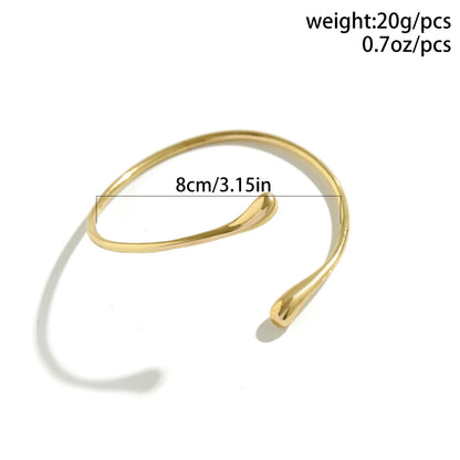 Brazalete de Brazo Dorado Minimalista - Emeraldia Jewelry · Operado por R. E. dos Santos LTDA · CNPJ: 45.450.979/0001-38
